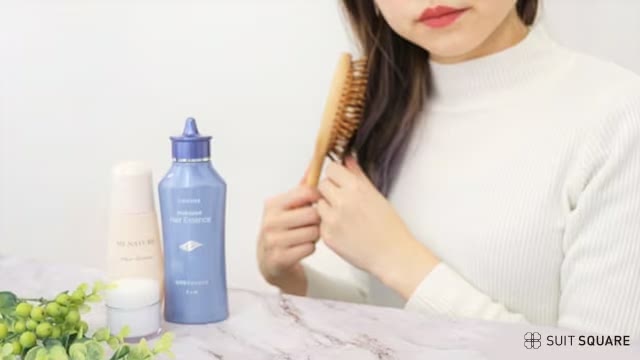 髪をとかす女性のイメージ画像